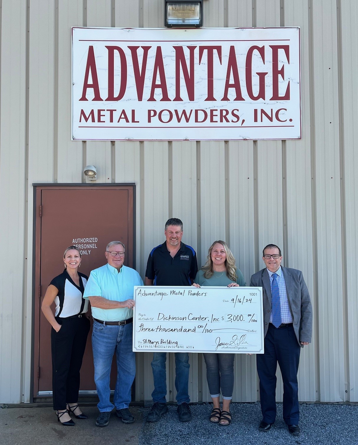 Photo of check presentation at Advantage Metal Powders